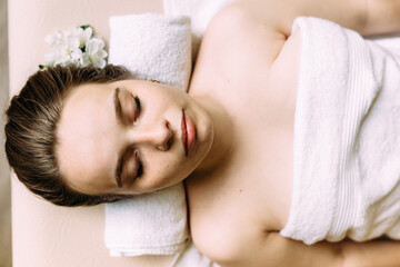 Fototapeta na wymiar Masseur doing massage on a woman's face at the spa.
