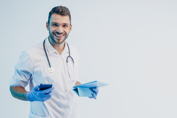 Male doctor with mobile phone and digital tablet