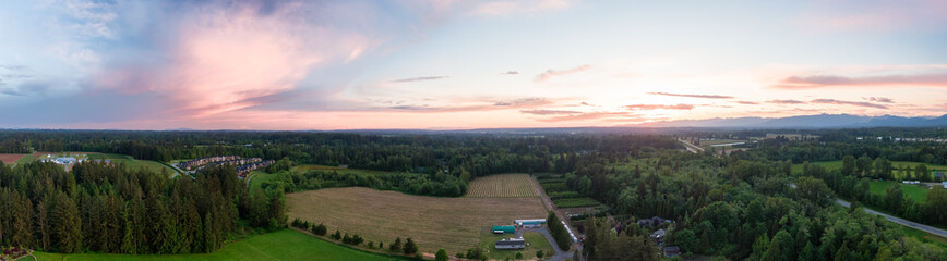 Aerial Panoramic View of Farm Fields in Fraser Valley during colorful Sunset. Taken in Langley, Greater Vancouver, British Columbia, Canada.