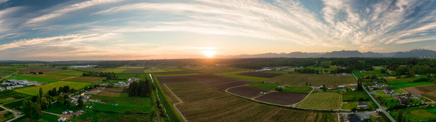 Aerial Panoramic View of Farm Fields in Fraser Valley during colorful Sunset. Taken in Langley, Greater Vancouver, British Columbia, Canada.