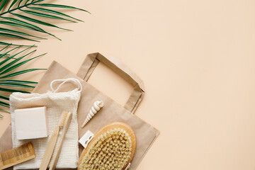 Fototapeta na wymiar Eco-friendly bathroom accessories: bamboo toothbrushes, bamboo ear sticks, organic soap, reusable cotton bags on beige background. Responsible consumption concept. Spa, skin care. Copy space.