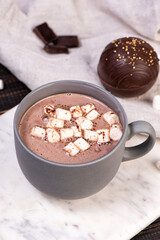 Chocolate ball bomb with marshmallows and milk