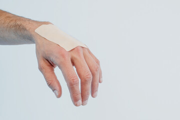 Close up of male hand with medical plaster