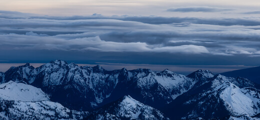 Obraz premium Aerial View from Airplane of Canadian Mountain Landscape in Spring time. Colorful Sunset Sky. North of Vancouver, British Columbia, Canada. Authentic Image