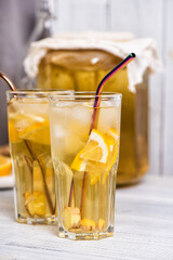 Homemade fermented kombucha tea drink with lemon and ginger