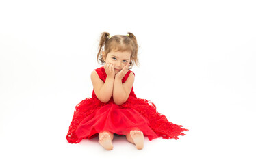 very fashionable little girl in a long bright red dress.Isolated on white background
