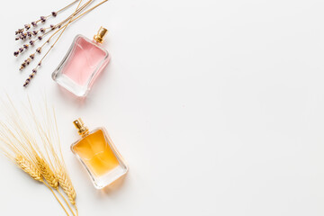 Perfume bottles flat lay with flowers and leaves, top view