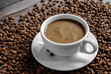 Coffee cup and coffee beans. Copy space. Espresso or Americano in a cup. Coffee beans background