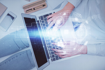 Double exposure of woman hands working on computer and social network theme hologram drawing. Top...