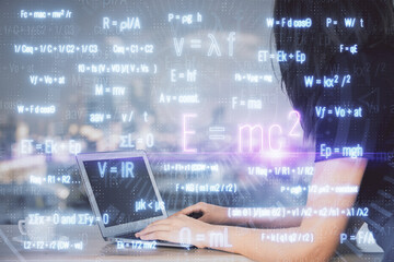 Fototapeta premium Double exposure of woman hands typing on computer and formula hologram drawing. Education concept.