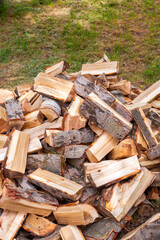 Chopped wood in a heap outside, prepared for the winter to heat the house. Fuel for stove and fireplace