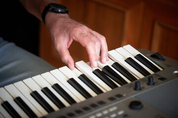 Close-up of a music performer's hand playing the electric piano