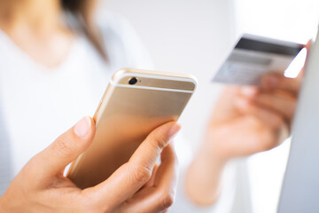 Woman using smart phone with a credit card. shopping online, Finance, online commercial.