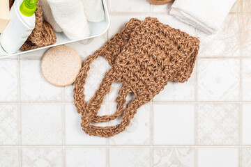 bath sponges, body washcloths, soap and towels on a light background. environmentally natural bathroom accessories