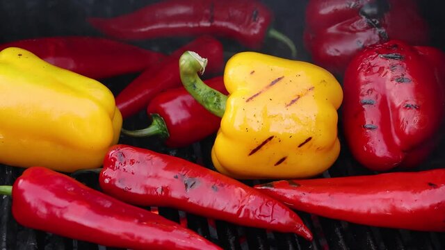 Cooking red and yellow bell peppers on grill