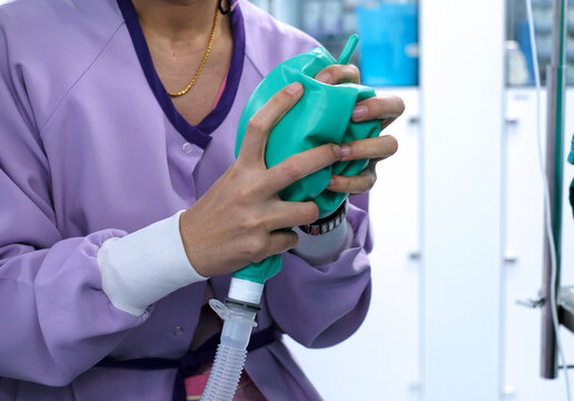 Nurse Squeezes Bag Of Ventilator Machine For Support Patient’s Ventilation