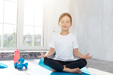 Concentrated girl practicing meditation in lotus position