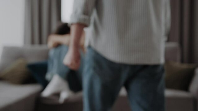 Woman scaring and protection of Man beating up, beaten and raped sitting in the corner ; violence concept