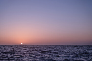 Sunset above Aegean sea, Greece. Calm sea. Sun goes down.