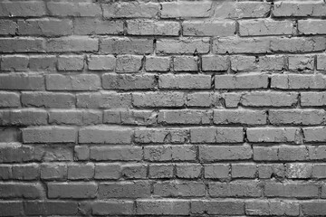 A gray brick wall. Background with a brickwork texture. The walls of street houses. Loft style.