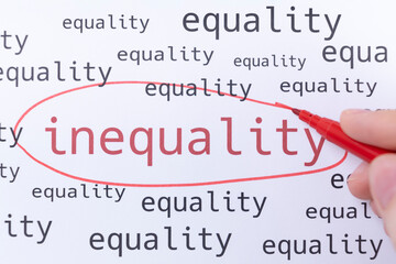 A hand with a pink marker is circling the word INEQUALITY.