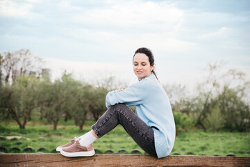 Freedom concept. Enjoyment. Young woman relaxing enjoying fresh air outdoor.