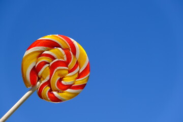 Colorful rainbow lollipop and nature background