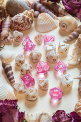 Vertical image of pink and white RPG dice
