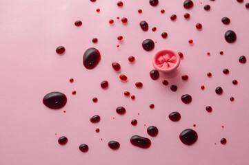 Metaphor of the anus on a pink background. Rectal bleeding, hemorrhoids.
