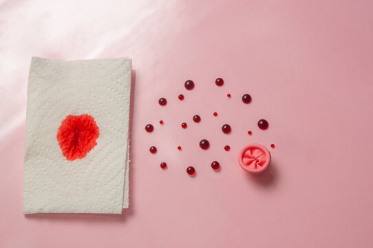 Metaphor of the anus on a pink background. Rectal bleeding, hemorrhoids.