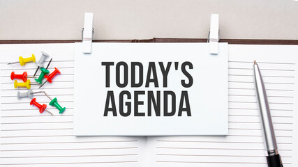 text today's agenda on stickers on the diary with office tools