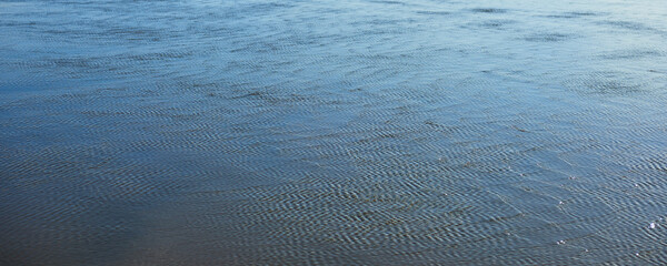Surface of the tide water on the ocean beach near Newport, Oregon.