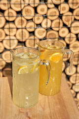 Cold Alcohol citrus coctail with orange juce and lime, mint and ice in a glass at the bar.