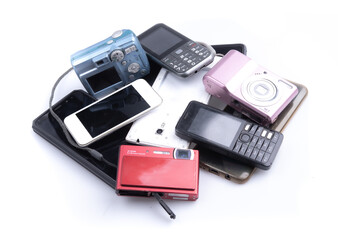 Pile of mobile phone and camera on white background, Reuse and Recycle concept