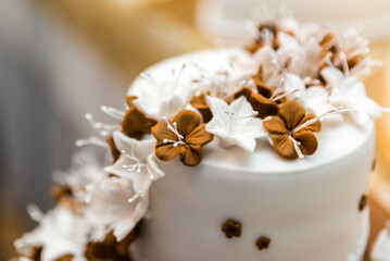 Detail of a wedding cake which is prepared at the reception so that it can be sliced by the bride and groom and eaten by guests