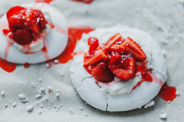 Homemade merengue with strawberry on plate