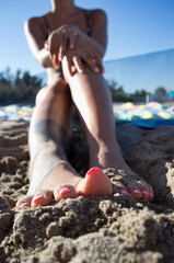Woman feet on the sand