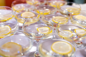 Sparkling alcoholic wine served in fairy tales with lemon for guests at a wedding, restaurant, celebration or ball.
