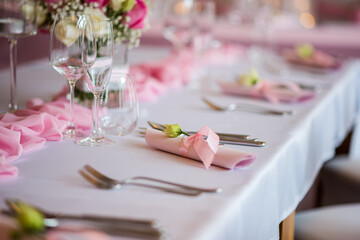Detail of flowers on a wedding table which is ready for the guests and bride with the groom.