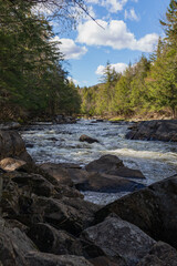 The gorgeous Sacandaga River with an expansive blue sky on a spring day.