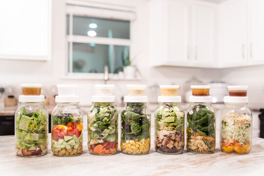 Fresh Meal Prep Salads Layered In Jars On Kitchen Counter