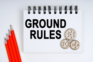 On a white background, there are red pencils, gears and a notebook with the inscription - GROUND...