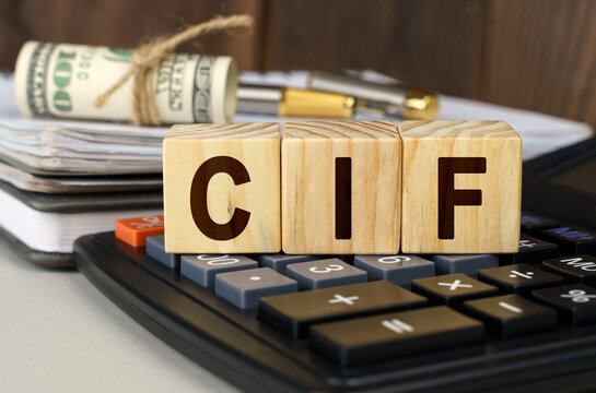 On the table are money, a calculator, a notebook and cubes with the inscription - CIF