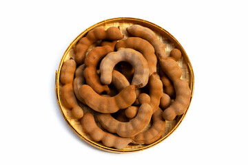 Tamarind tropical fruits in bamboo basket on white background.
