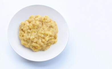 Mashed Bananas in white plate on white background.