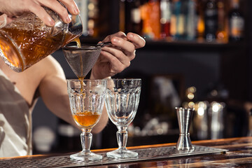 Cocktail bars, bartender making a cocktail February 6th Bartender's Day, toned