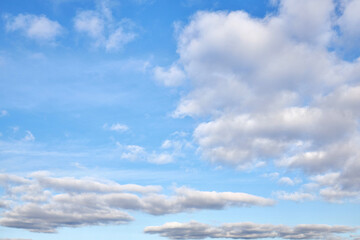Natural daylight and white clouds floating across a blue sky