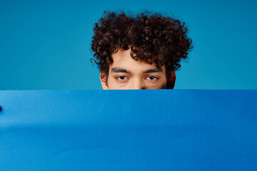 guy with curly hair blue poppy poster advertising