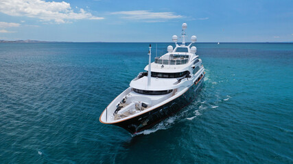 Fototapeta na wymiar Aerial drone photo of modern luxury yacht cruising near Mediterranean port