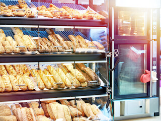 Fresh bread and pastries on shelves in bakery